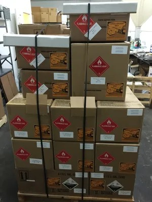 A stack of boxes with red stickers on them.