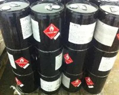 A stack of barrels with stickers on them.